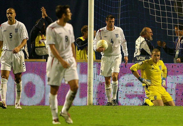 Paul Robinson, right, sinks to his knees after being caught out by the bounce in Zagreb