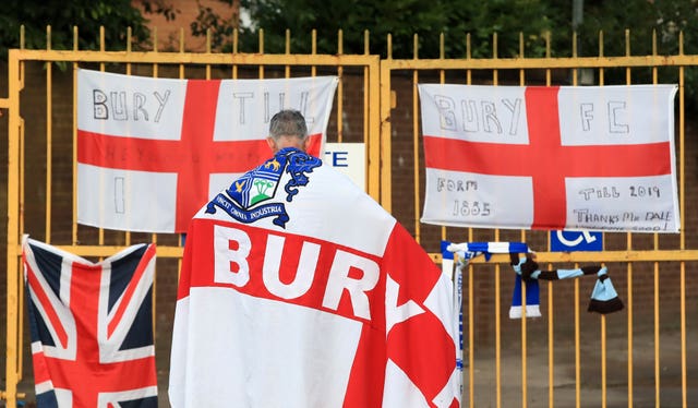 A Bury fan at the gates of Gigg Lane