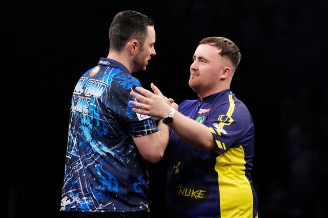 Luke Humphries, left, is embraced by Luke Littler