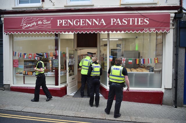 Police officers queuing for breakfast outside Pengenna Pasties in St Ives during the G7 summit in Cornwall