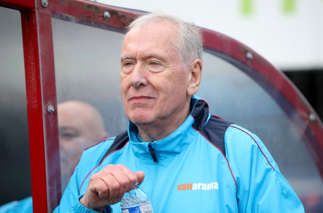Martin Tyler, pictured during Woking's defeat to Watford, is part of the non-league club's coaching staff 