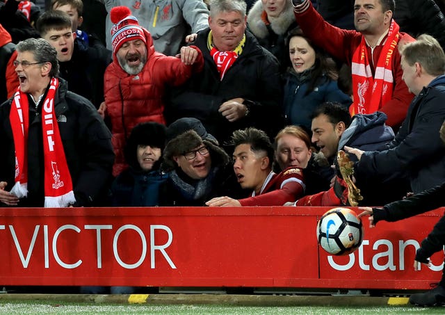 Firmino reacted angrily after he was pushed over the advertising hoardings by Holgate