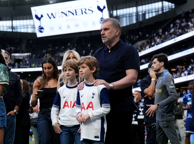 Postecoglou with his family on the pitch after the match