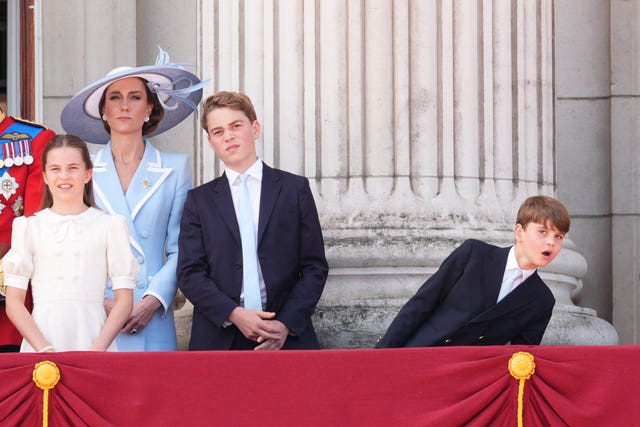 Prince Louis leaning away from his family