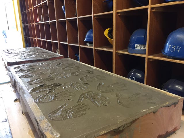 Handprints left by former shipyard workers in wet cement