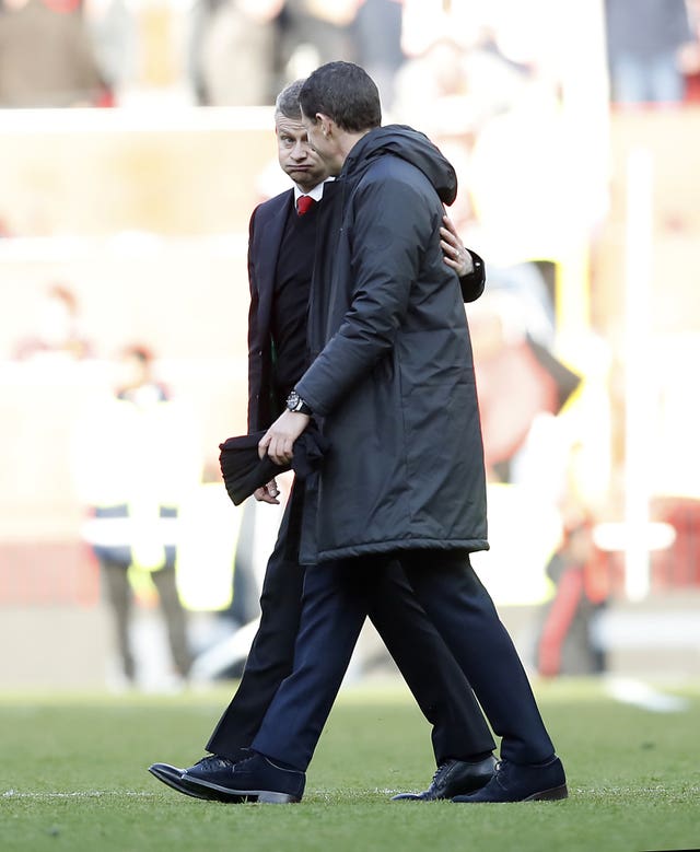 Ole Gunnar Solskjaer, left, shows his relief as he leaves the field with Watford manager Javi Gracia after Manchester United's 2-1 win