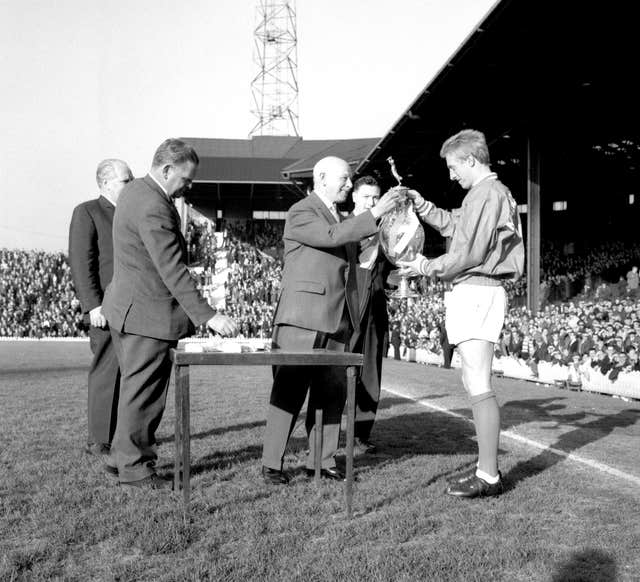 Denis Law, right, receives the Football League trophy in 1965