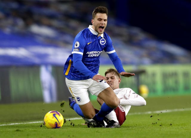 Arsenal’s Emile Smith Rowe, right, tackles Brighton’s Joel Veltman