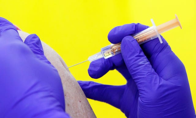 A member of the public receives the Oxford/AstraZeneca coronavirus vaccine at the Elland Road vaccination centre in Leeds (Danny Lawson/PA)