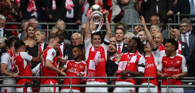 Arsenal midfielder Granit Xhaka lifts the FA Cup