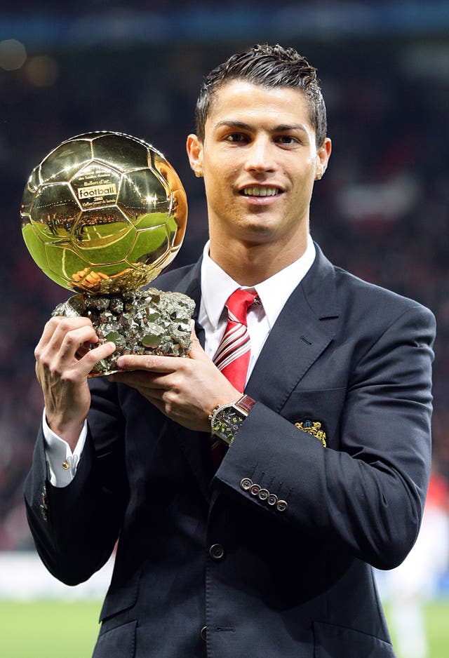 Cristiano Ronaldo poses with one of his five Ballons d'Or