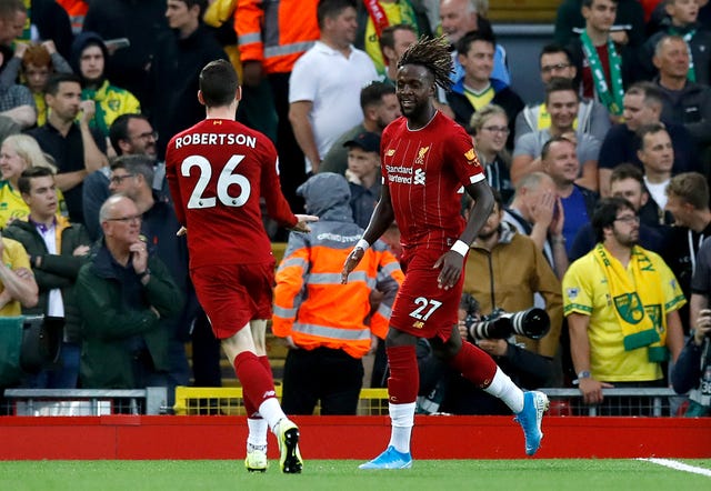 Divock Origi, right, celebrates with team-mate Andy Robertson 