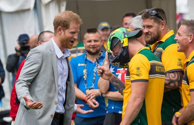 Benjamin Yeomans asks Harry to sign a pair of swimming trunks