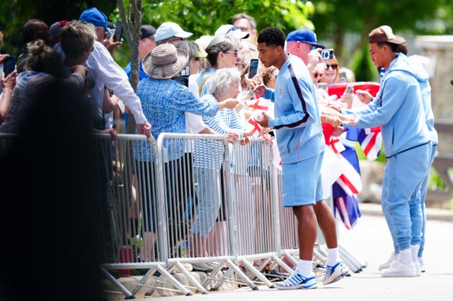 Jude Bellingham and Morgan Rogers sign autographs outside England's hotel