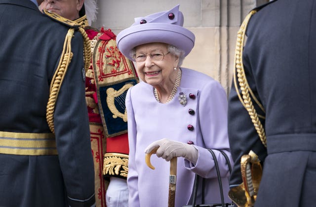 Queen Elizabeth II attends an armed forces act of loyalty parade in the gardens of the Palace of Holyroodhouse in 2022