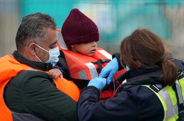 A young boy is helped by a Border Force officer in Dover