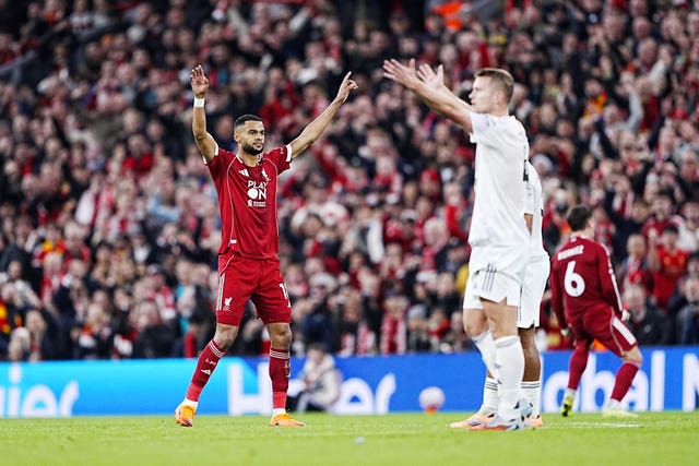 Cody Gakpo raises his arms in celebration after scoring