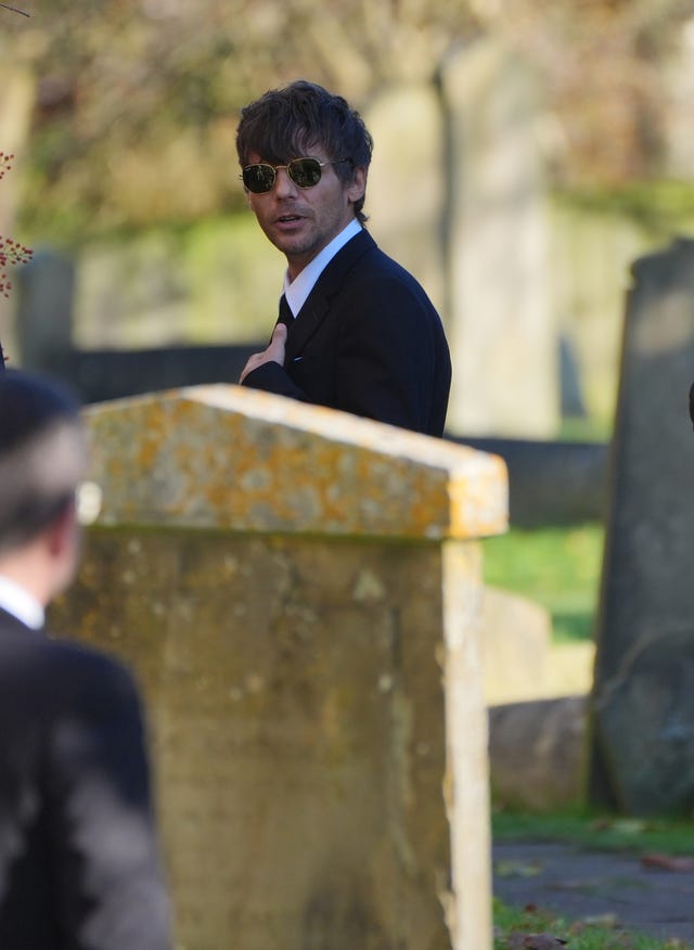 Former One Direction band member Louis Tomlinson arrives for the funeral service of One Direction singer Liam Payne