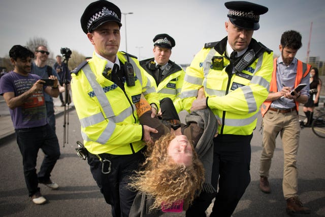 Police carry a climate activist away on Waterloo Bridge