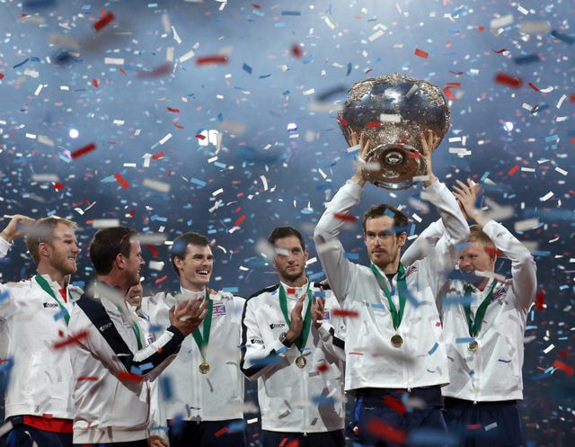 Murray holds the trophy aloft after his defeat of David Goffin sealed Great Britain's Davis Cup triumph