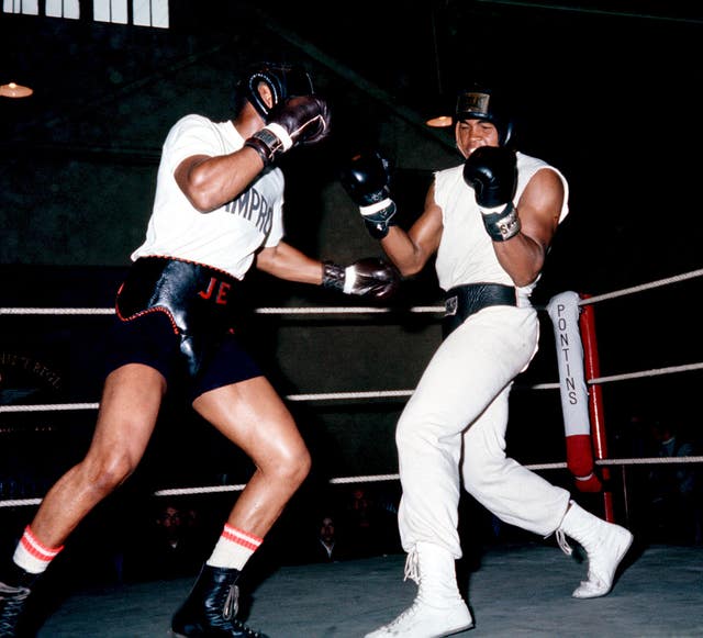 Clowing Muhammad Ali - then known as Cassius Clay - takes a right from sparring partner Jimmy Ellis of Kentucky during training at the White City drill hall for his world heavyweight title defence against Henry Cooper