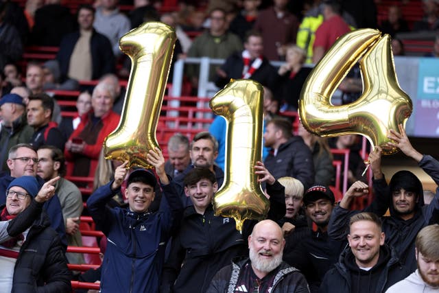 Liverpool fans hold up balloons that show ‘114’