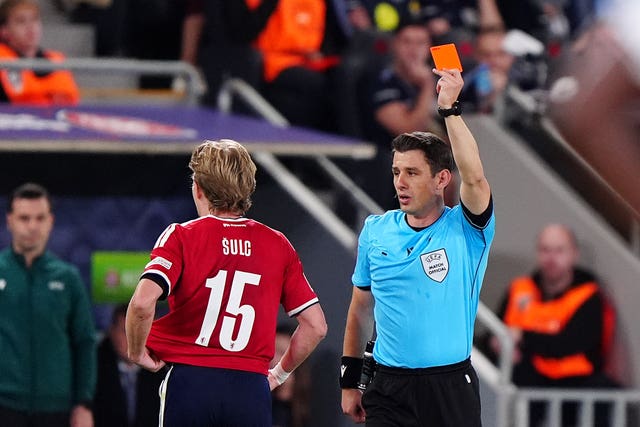 Czechia’s Pavel Sulc, left, is shown a red card by referee Umut Meler