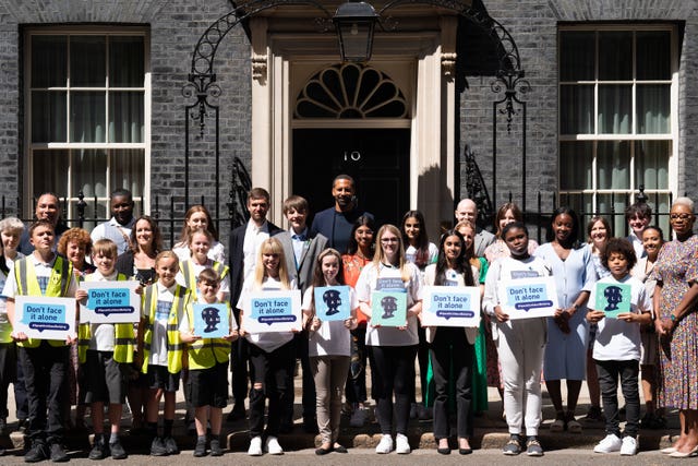 Rio Ferdinand poses for photographs with children at 10 Downing Street to celebrate the launch of the Diana Award’s annual anti-bullying campaign Don’t Face It Alone (Stefan Rousseau/PA)