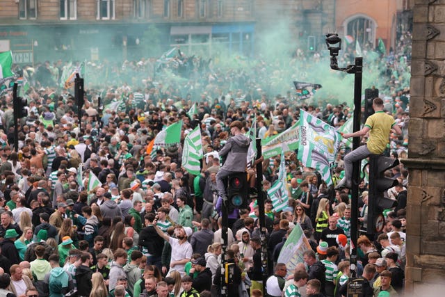 Celtic fans celebrate in Glasgow after their side won the William Hill Premiership title after a 3-1 win at home to Hearts