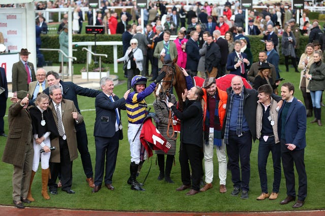 Derek Fox (centre left) and connections of Corach Rambler celebrate at Cheltenham