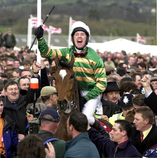 Charlie Swan is cheered by a packed crowd following Istabraq's third Champion Hurdle