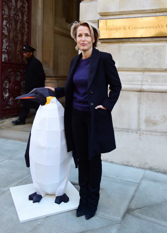 Gillian Anderson was joined by a penguin sculpture 'marching' for protection to deliver the Antarctic petition (David Mirzoeff/PA)