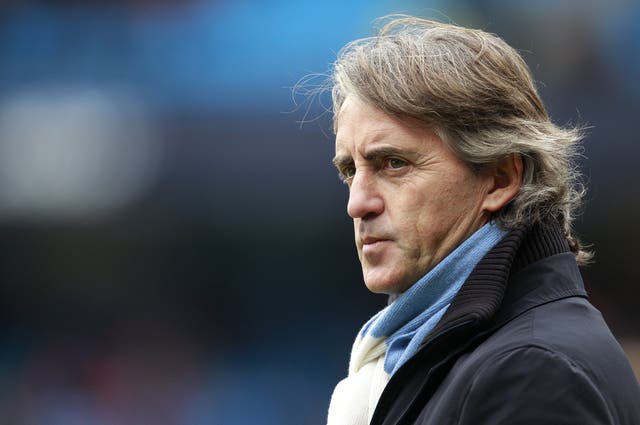 Roberto Mancini in a Manchester City scarf during his time as manager of the club