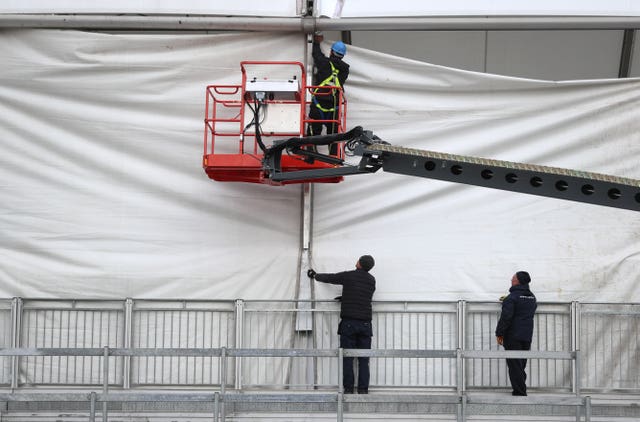 Up and running: Fears that gales might postpone the Queen Mother card until Saturday were dispelled long before a scheduled 8am inspection, and preparations for another big day were soon under wa