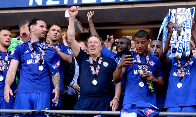 Neil Warnock celebrates winning promotion to the Premier League