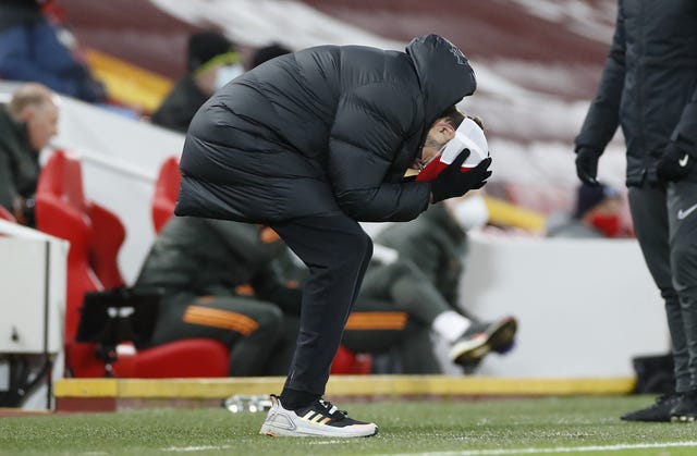 Liverpool manager Jurgen Klopp bends double holding his head in his hands