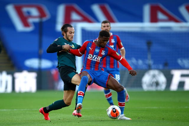 Josh Brownhill, left, and Crystal Palace’s Wilfried Zaha battle for the ball