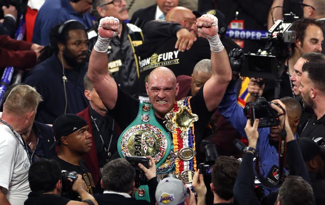 Tyson Fury, centre, is the WBC heavyweight champion (Bradley Collyer/PA)