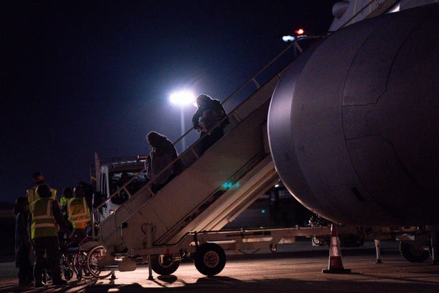 British nationals and Afghan evacuees depart a flight from Afghanistan at RAF Brize Norton (PA/Jacob King)
