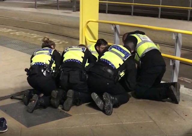 Police restraining the suspect (Sam Clack/PA)
