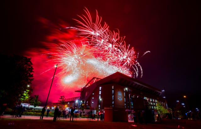 Fireworks light up the night sky above Anfield Stadium as Liverpool lift the Premier League trophy. Despite being urged to stay at home by the club, a number of Reds fans turned up at the stadium to savour a memorable moment