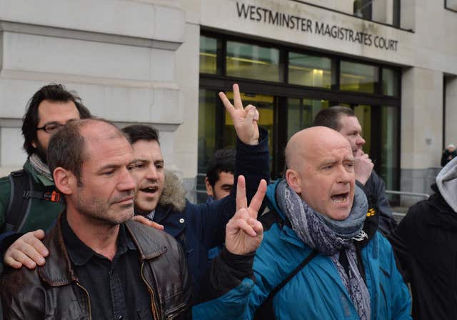 James Matthews, left, is greeted by supporters as he arrives at Westminster Magistrates' Court (Dominic Lipinski/PA)