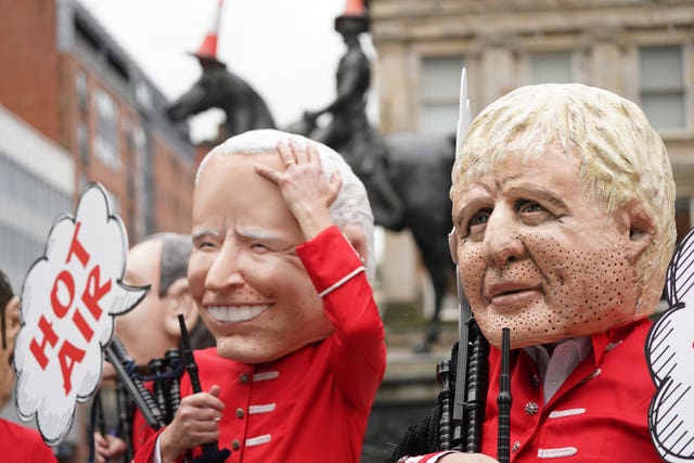 Joe Biden and Boris Johnson as Oxfam's big heads