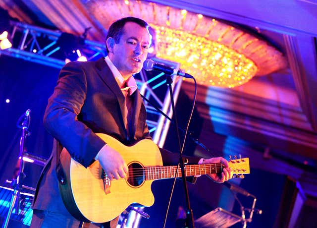 Michael Dugher  on guitar (Ian West/PA)