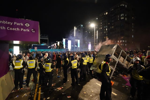 England fans and police are seen outside of the ground after the Euro 2020 Final