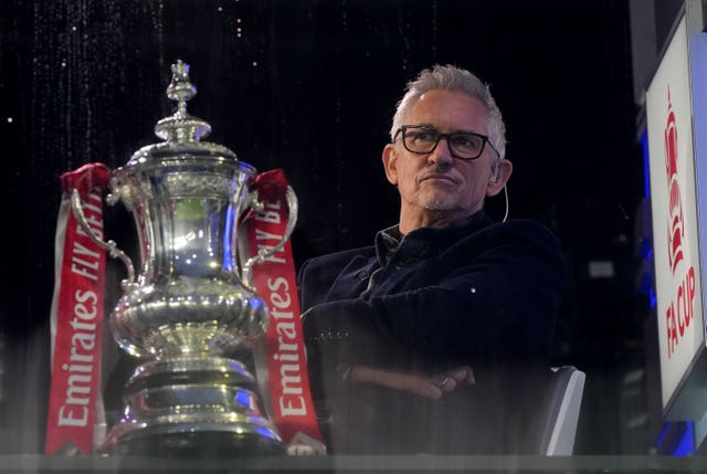 Gary Lineker sits by the FA Cup while presenting for the BBC
