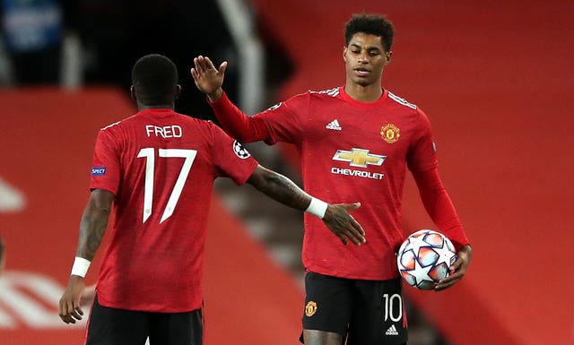 Marcus Rashford holds the match ball after his hat-trick