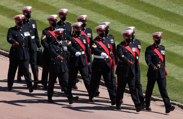 Members of the military march outside St George’s Chapel