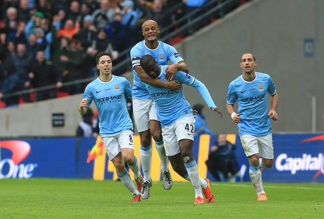Yaya Toure is congratulated after scoring Manchester City's equaliser