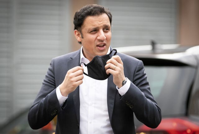 Anas Sarwar taking off his mask